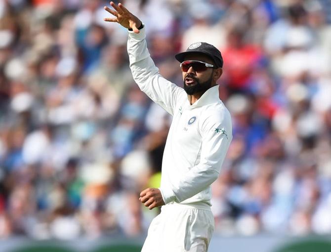 Virat Kohli does the mic drop celebration after taking the wicket of England's Joe Root 